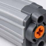 Macro detail shows the molded plastic ribs, dark end cap and orange axle socket.