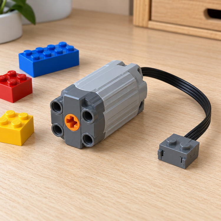 Medium building-block motor and cable shown beside loose blocks for scale on a desk.