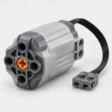 Servo steering motor with black cable and gray connector on a light studio backdrop.