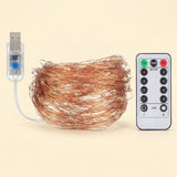 Coiled copper wire string lights in warm white shown unlit with a USB controller and remote control on a beige background.