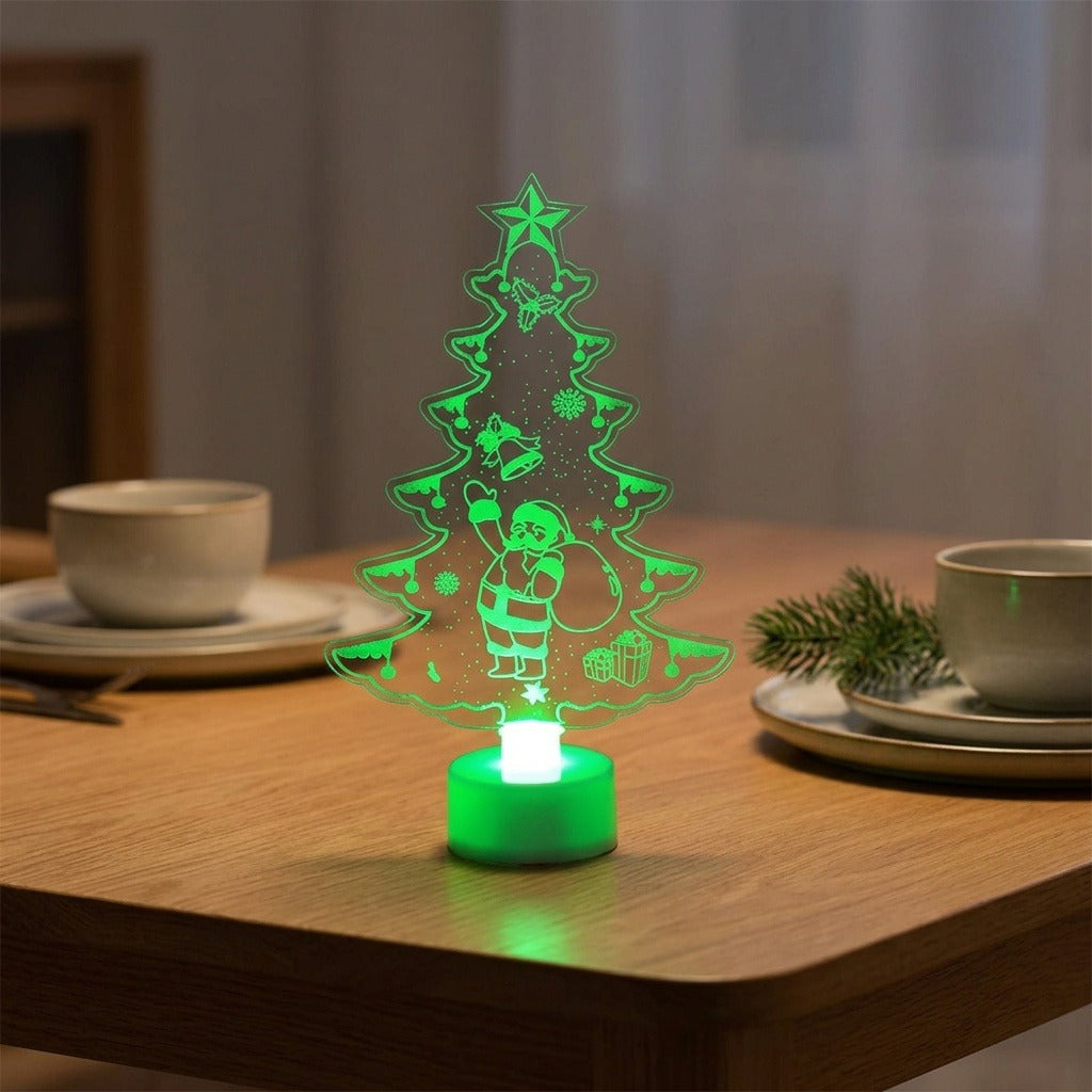 A glowing LED Christmas tree night light shaped like a tree silhouette with a Santa Claus figure, placed on a wooden table in a softly lit dining setting.