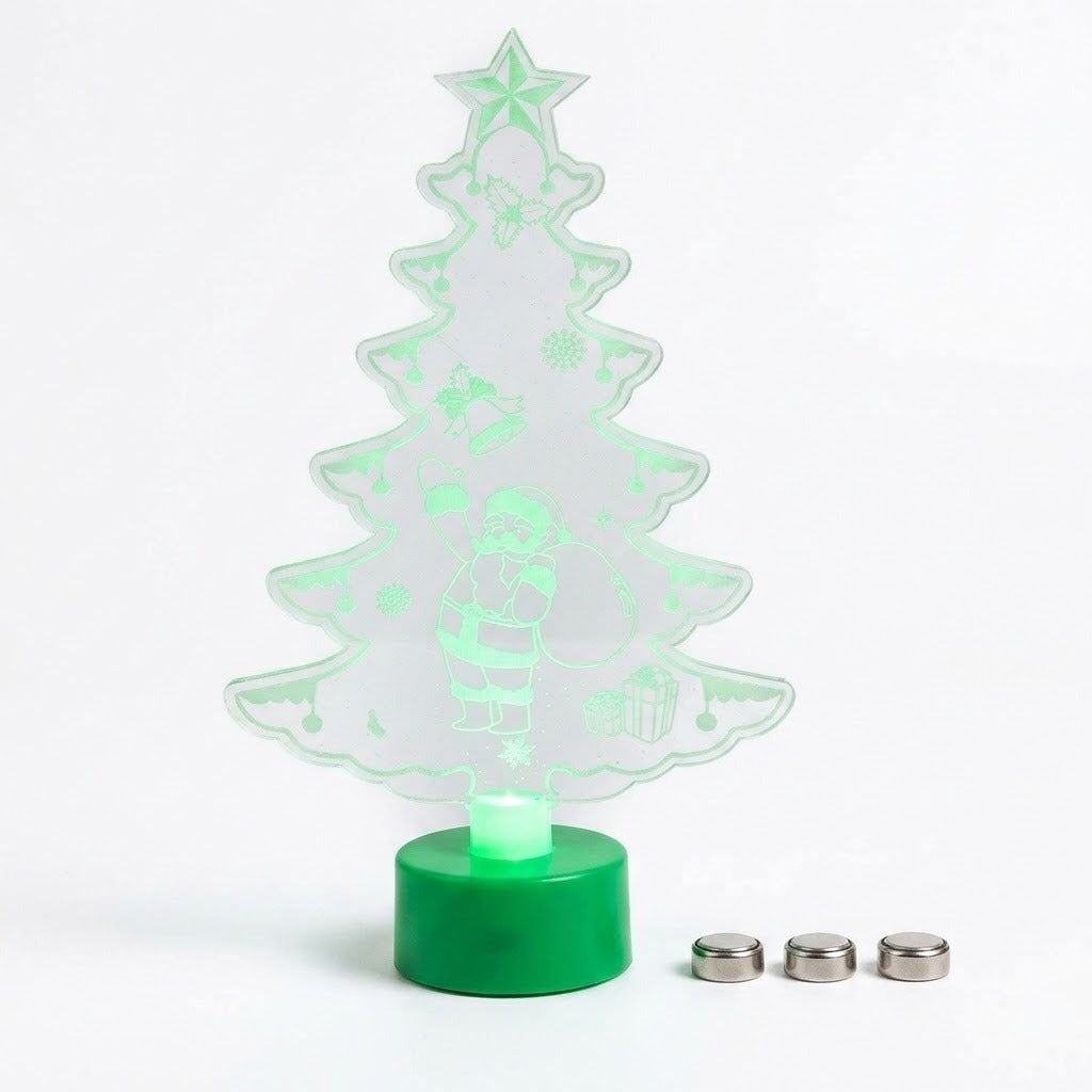 A 3D optical illusion LED night light shaped like a Christmas tree, featuring a glowing green silhouette with festive details and a green cylindrical base, shown with three small silver batteries on a white background.