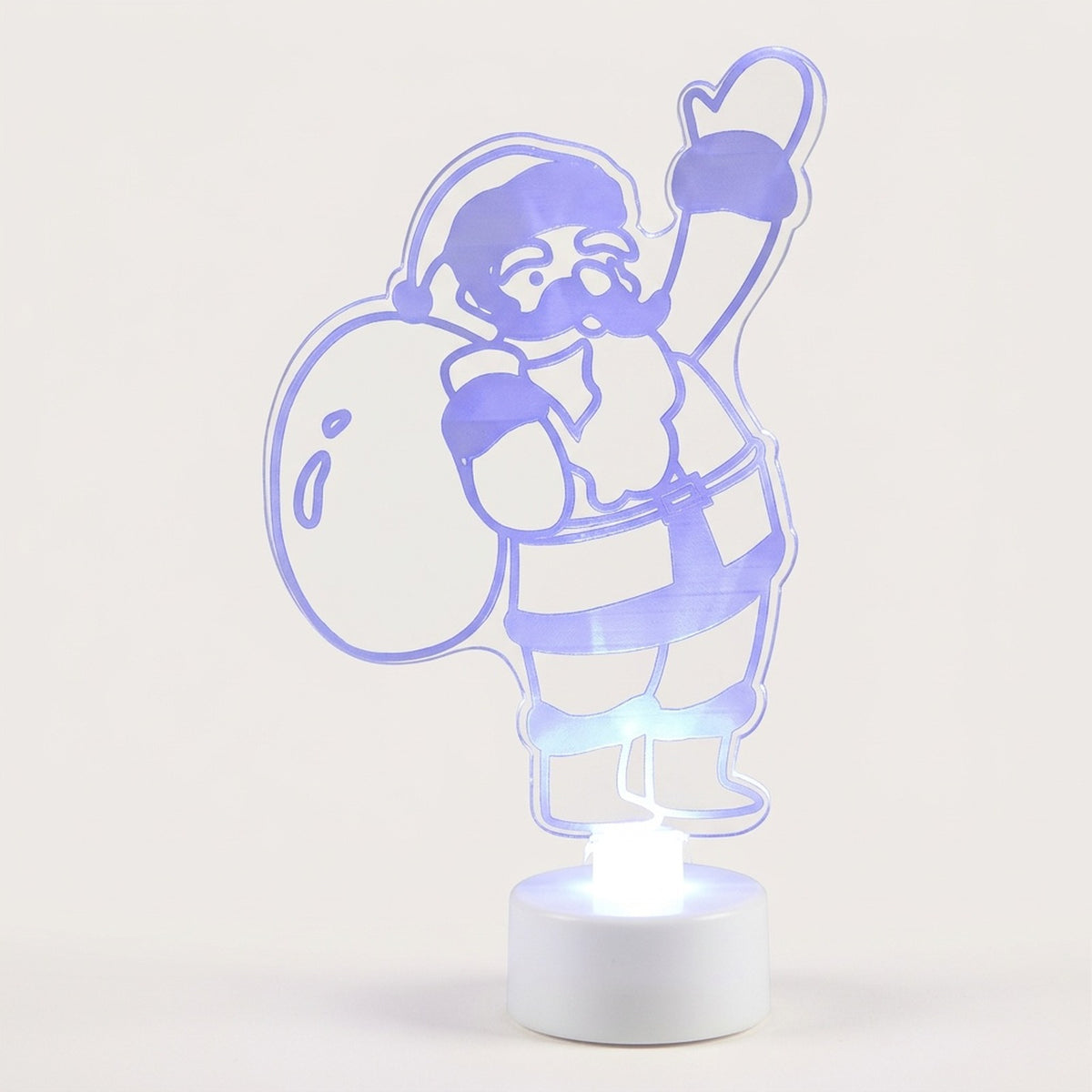 A 3D optical illusion LED night light shaped like Santa Claus waving while carrying a sack, illuminated with a cool blue-purple light on a white base against a light beige background.