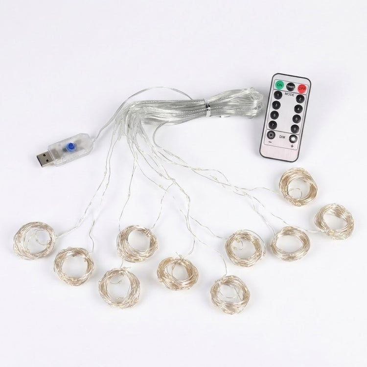 An LED curtain light has coiled clear strands, a connected USB controller and a white remote arranged on a white background.