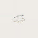 An unlit curtain light with clear wiring and small coiled strands sits beside a USB connector and white remote on an off-white background.