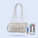 An unlit curtain light has clear strands gathered into hanging coils beside a USB connector and white remote against pale blue.