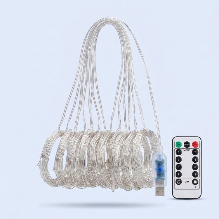 An unlit curtain light has clear strands gathered into hanging coils beside a USB connector and white remote against pale blue.