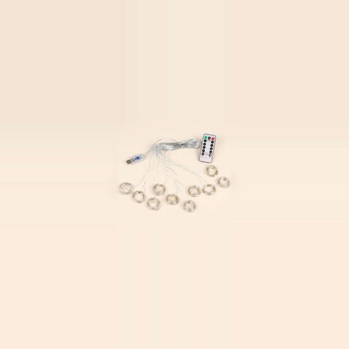 An LED curtain light with coiled clear strands, a USB controller and a white remote sits centered against a spacious cream background.