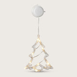 A clear Christmas tree-shaped window light with warm LEDs hangs below a round white housing against an off-white background.