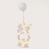 Clear Santa Claus-shaped window light glows warm white beneath a round white battery box and suction cup against a pale background.