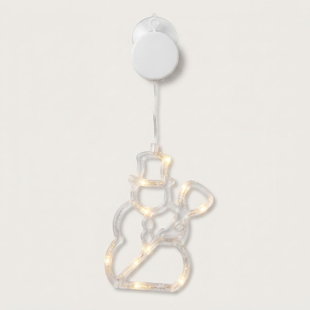 Clear snowman-shaped window light with warm white LEDs hangs beneath a white battery box and suction cup against a pale background.