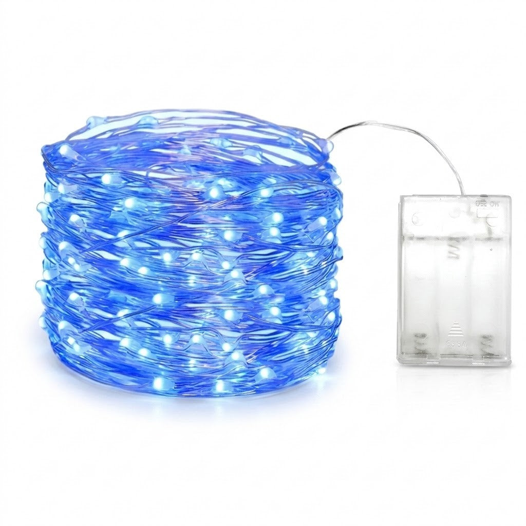 Blue LED fairy string lights coiled in a ball next to a clear plastic battery compartment on a white background.