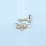 An unlit LED curtain light has coiled clear strands, a USB controller, and a white remote on a pale blue background.