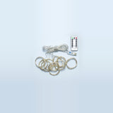 LED curtain light with coiled silver-colored wires, a USB connector, and a white remote on a pale blue background.