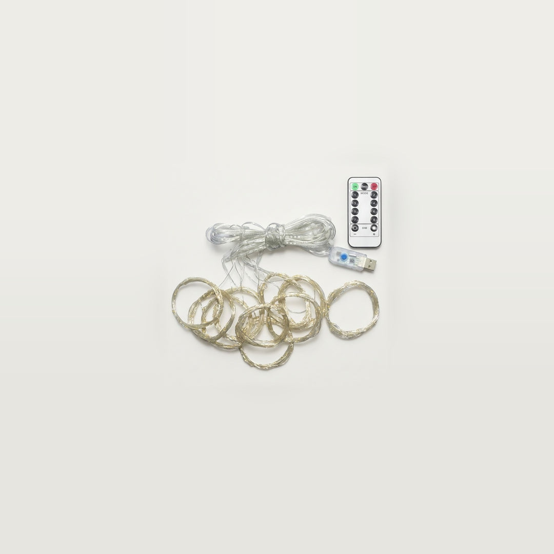 An unlit LED curtain light has coiled clear strands beneath a bundled cable, with a USB controller and white remote on light gray.