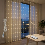 Warm white LED curtain lights hang across sheer curtains, with a coiled USB cable beside them and a remote on a wooden table.