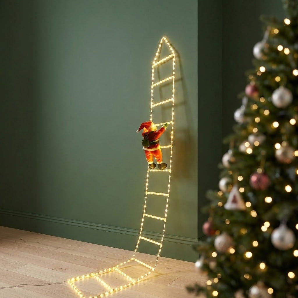 A Christmas-themed scene showing a small Santa Claus figurine climbing a ladder-shaped string light display against a dark green wall, with a decorated Christmas tree partially visible on the right.