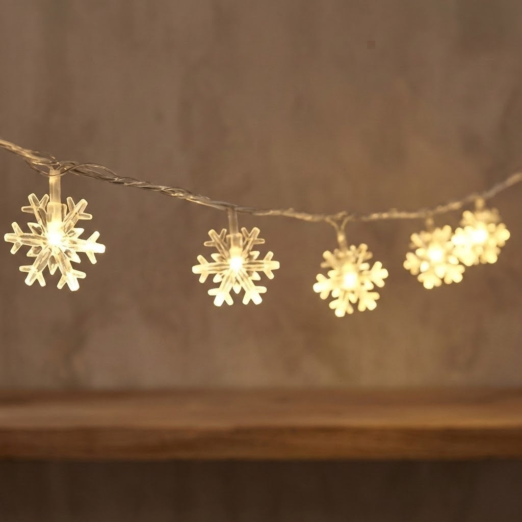 Warm-white snowflake curtain lights hang from clear twisted wire against a softly blurred brown background.