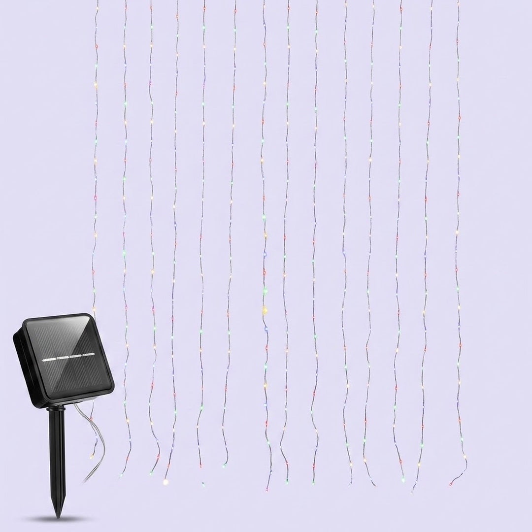 Multicolor solar curtain light with thin vertical strands and a black solar panel on a ground stake against a pale lavender background.