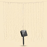 Solar LED curtain light with thin hanging strands and a black solar panel on a pointed stake against a beige background.
