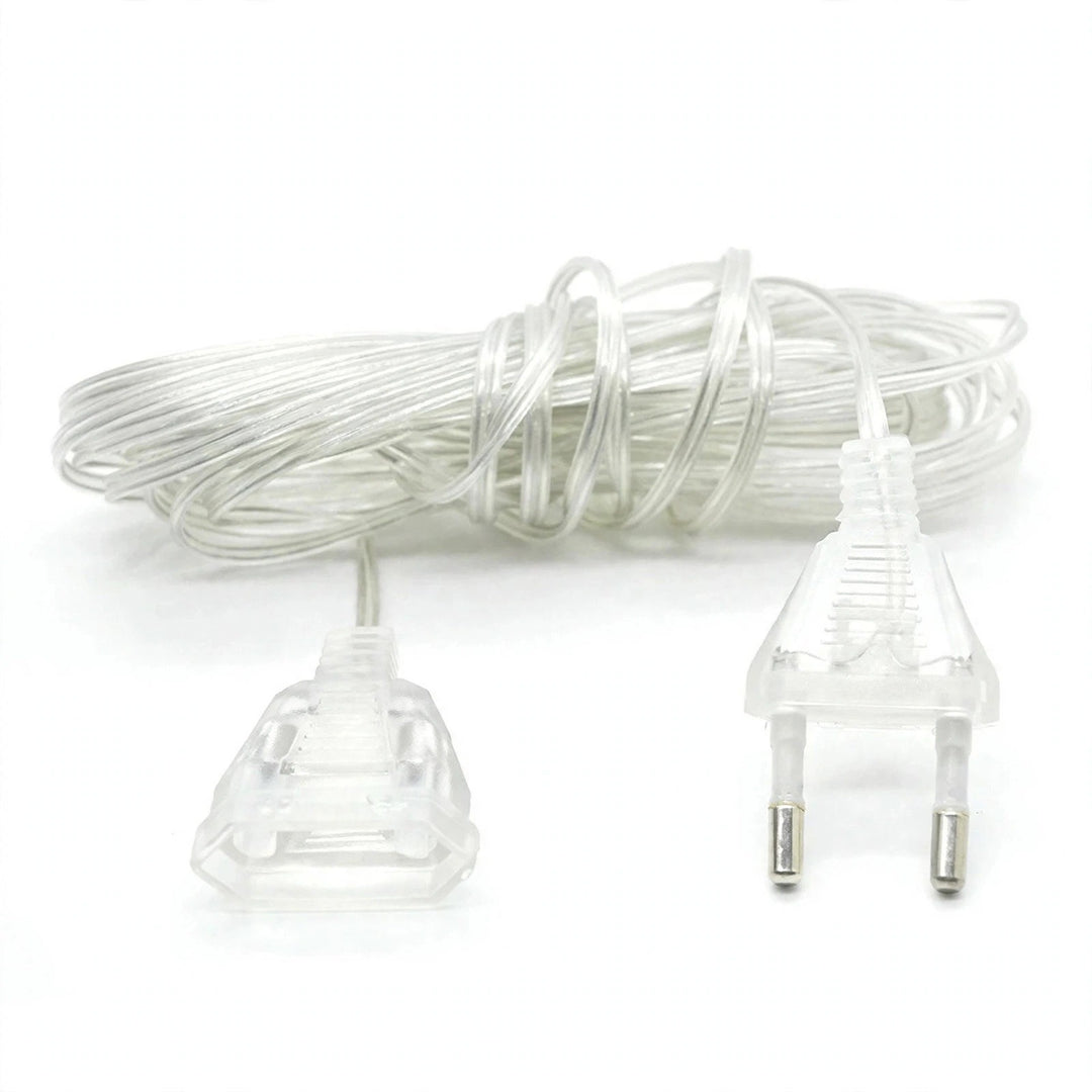 A coiled clear plastic extension cord with a two-pin European plug on one end and a multi-pin plug on the other, shown on a white background.