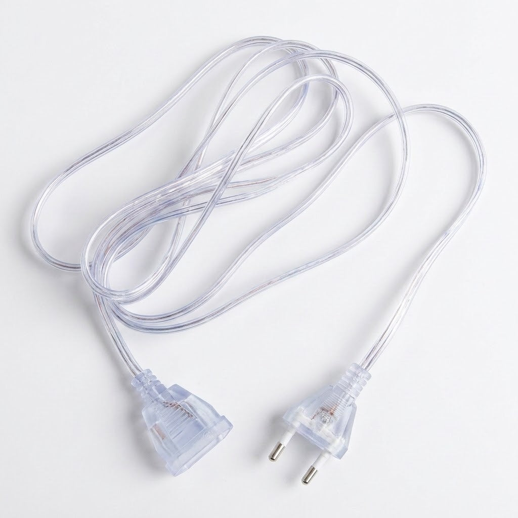 A clear plastic extension cord with a two-pin European plug on one end and a three-pin plug on the other, coiled on a white background.