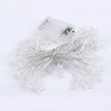 White star-shaped fairy string lights with a clear battery compartment, arranged on a white background.
