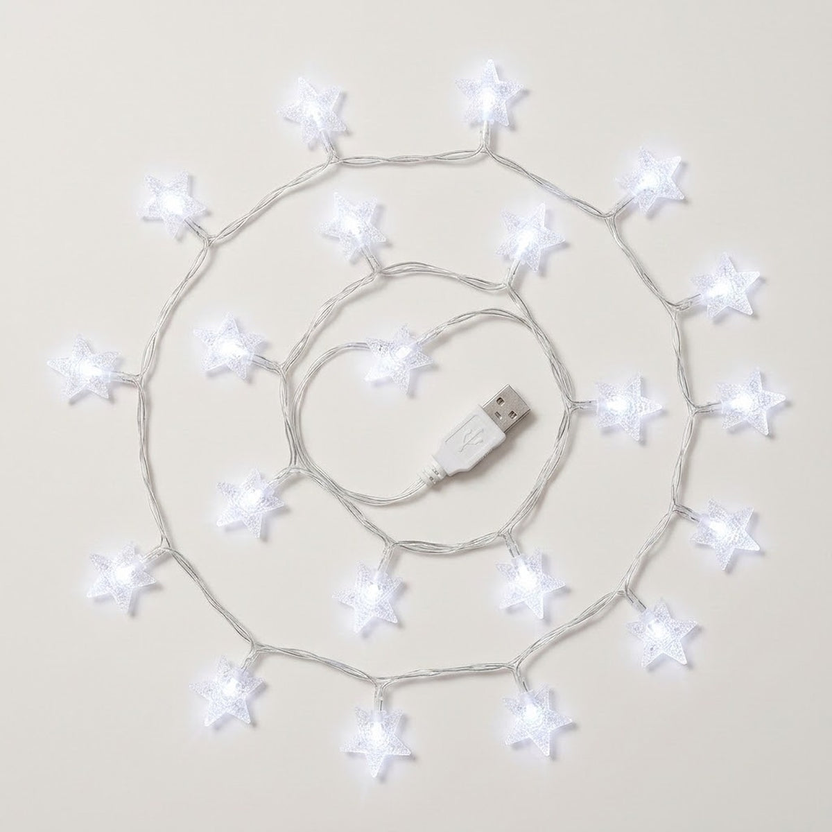 White star-shaped USB string lights arranged in a spiral pattern on a light beige background.