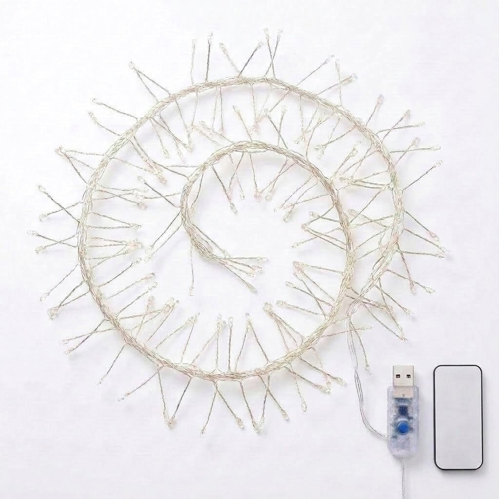 Coiled white LED fairy string lights with a USB connector and a small rectangular remote on a plain white background.