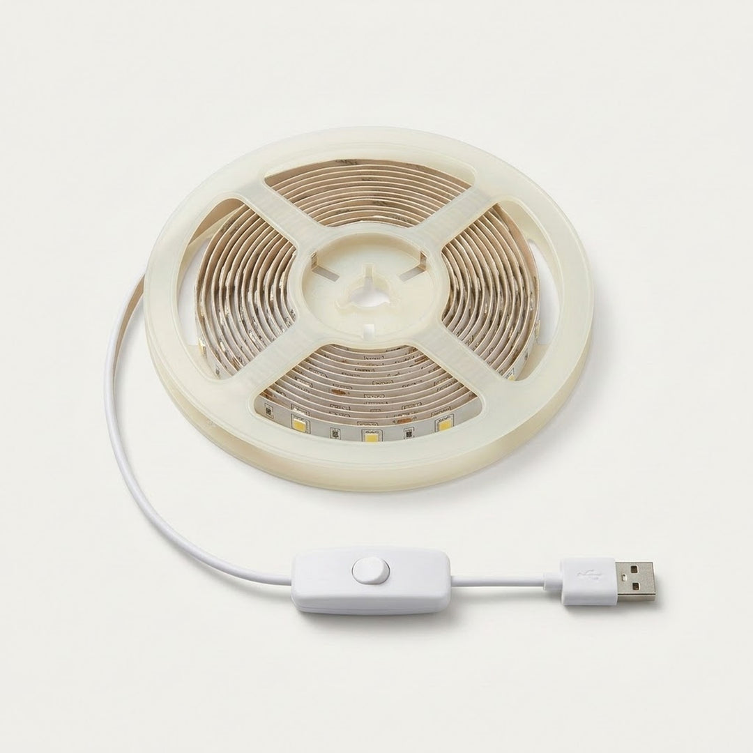A coiled LED strip light with a white USB cable and inline switch, shown on a clean off-white background.