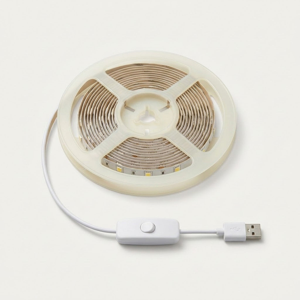 A coiled LED strip light with a white USB cable and inline switch, shown on a clean off-white background.
