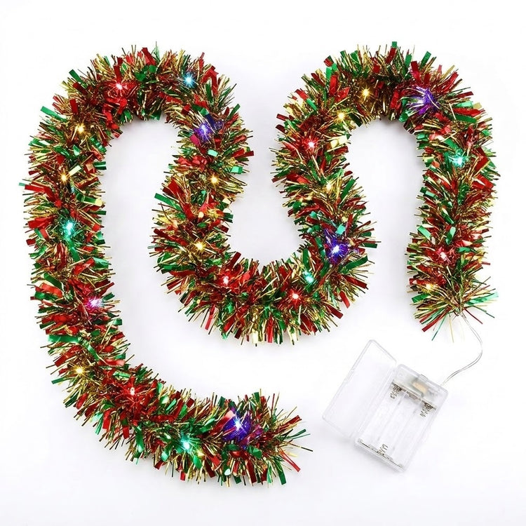 Red, green, and gold Christmas tinsel garland with built-in multicolor LED lights, shown coiled on a white background with a clear battery compartment visible.