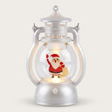 A silver decorative lantern with warm light and Santa holding a yellow gift sack stands against an off-white background.