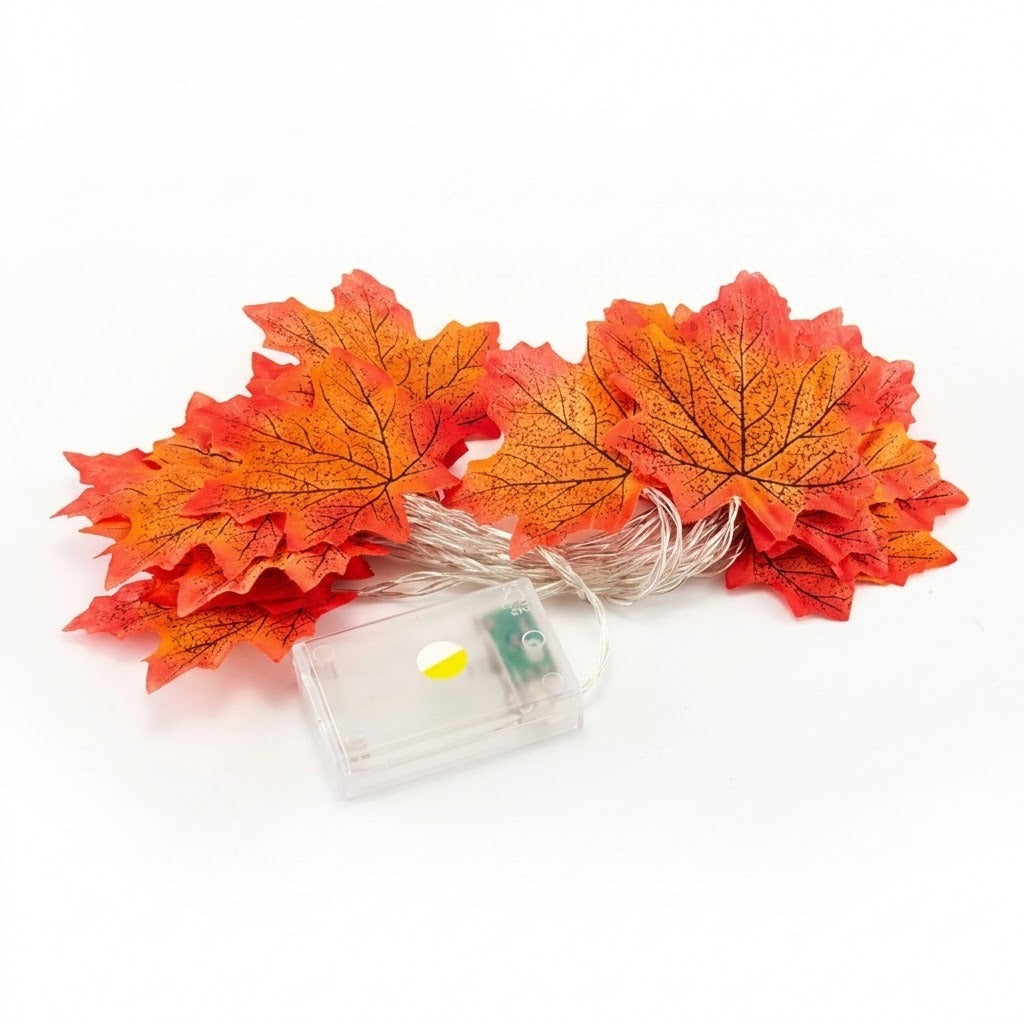 Artificial autumn maple leaf string lights with a small clear battery box on a white background.