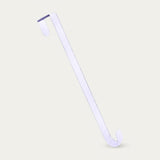 A white zinc alloy wreath hanger stands diagonally against a light beige background, showing its bent top and curved lower hook.