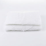 A white snow blanket is folded into stacked rectangular layers against a plain white background.