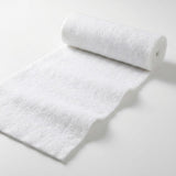 A white snow blanket roll sits partially unrolled on a plain white background, showing its fluffy texture and slightly uneven edges.