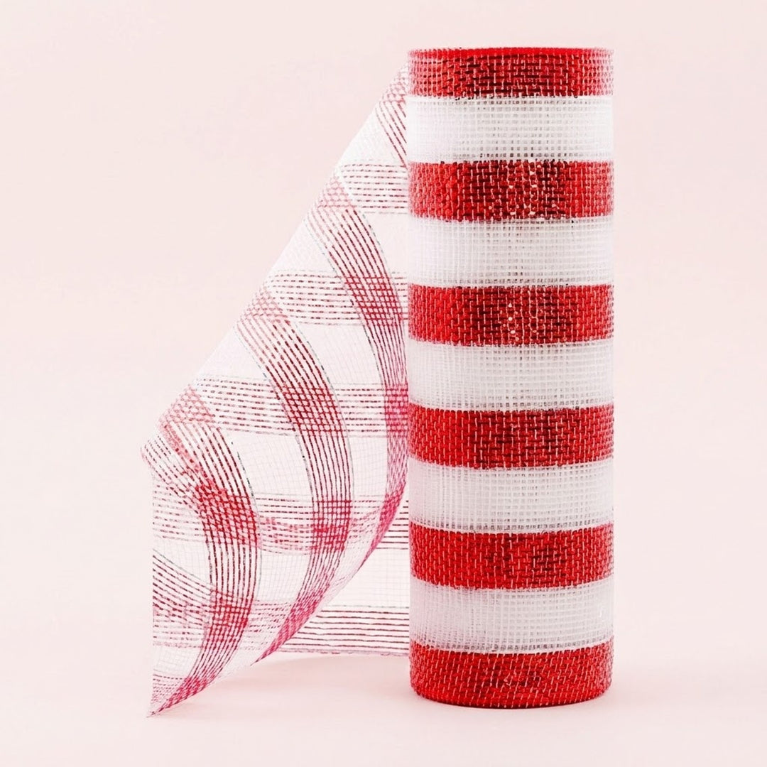 Red and white striped mesh decorative ribbon stands in an upright roll with a loose curled end against a pale pink background.
