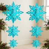 Six turquoise 3D snowflake ornaments hang in two columns beside a window, framed by evergreen branches, pinecones, and red berries.