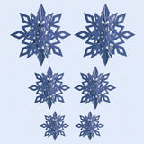 Six metallic blue 3D snowflake ornaments with diamond cutouts hang in three size pairs against a pale blue background.