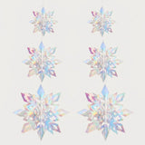 Six iridescent 3D snowflake ornaments with pastel rainbow reflections hang in two columns, increasing in size downward against an off-white background.