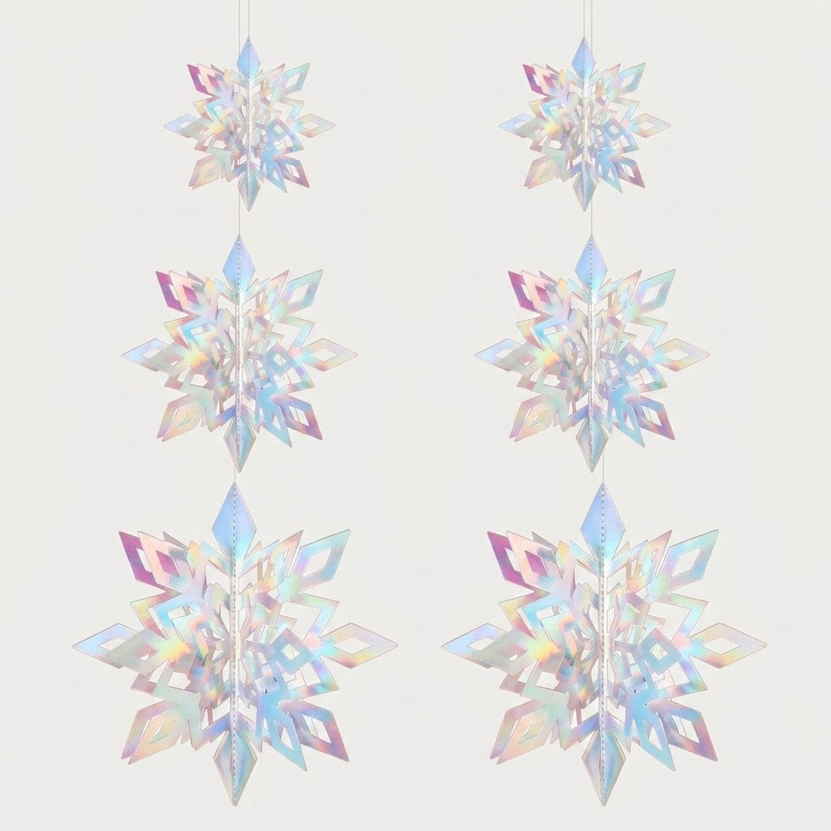 Six iridescent 3D snowflake ornaments with pastel rainbow reflections hang in two columns, increasing in size downward against an off-white background.