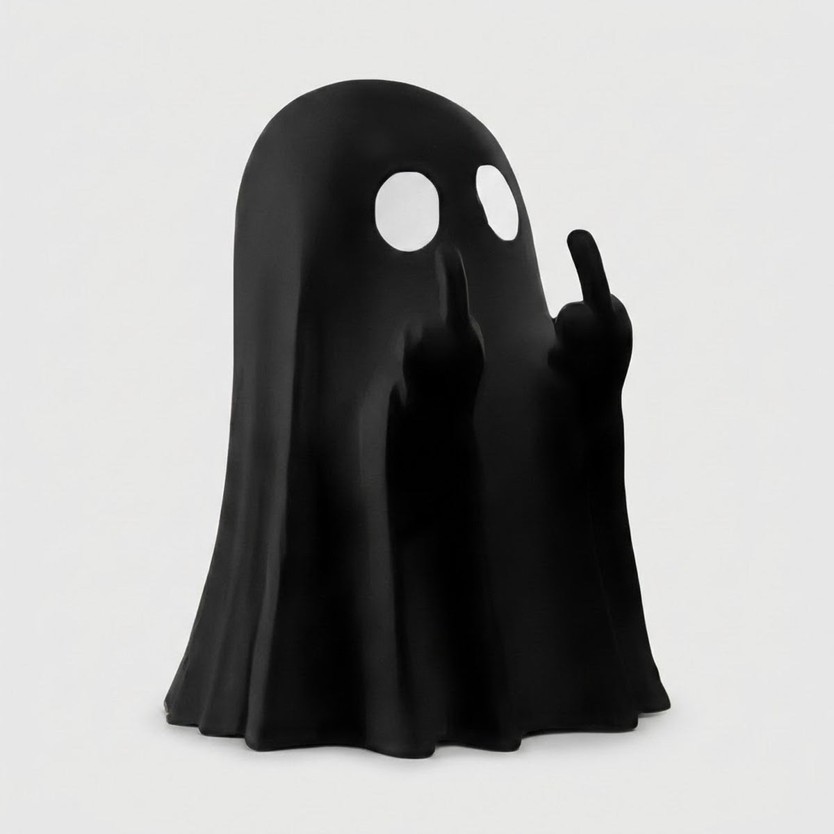 A black ghost-shaped figurine or lamp with two white circular eye cutouts and raised hands showing middle fingers, photographed on a plain light gray background.