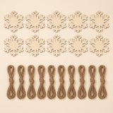 Ten unfinished wood snowflake ornament blanks with hanging holes sit above ten brown twine bundles on a cream background.