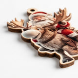 A close-up of a wooden Christmas ornament featuring a smiling reindeer and Santa Claus, photographed on a clean white background.