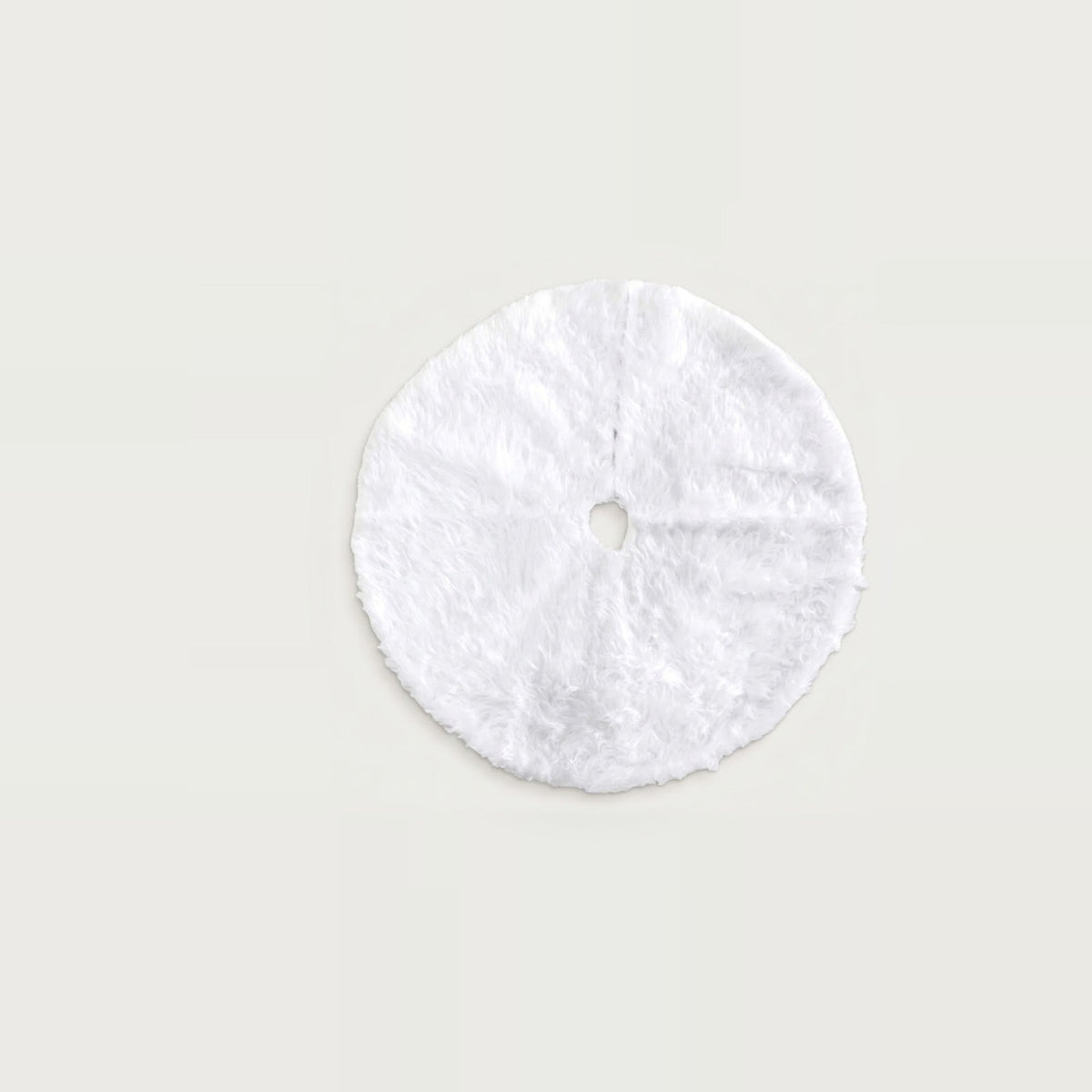 Round white fluffy Christmas tree skirt with a central hole and slit, displayed flat against a light neutral background.