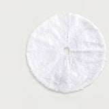 White fluffy circular Christmas tree skirt with a central opening and radial slit, laid flat on a light background.