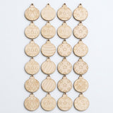Unfinished wood ornament craft set displays twenty-four pale round blanks with assorted Christmas patterns in six rows against a white background.