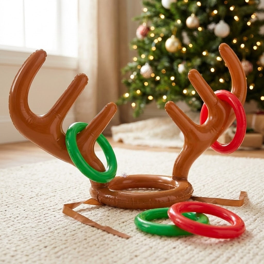 Inflatable reindeer antler ring toss game with brown headgear and red and green rings on a cream rug before a Christmas tree.