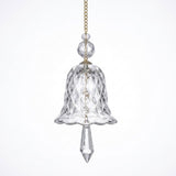 A clear bell-shaped glass suncatcher with diamond-patterned sides, two faceted beads, and a pointed drop hangs against a white background.